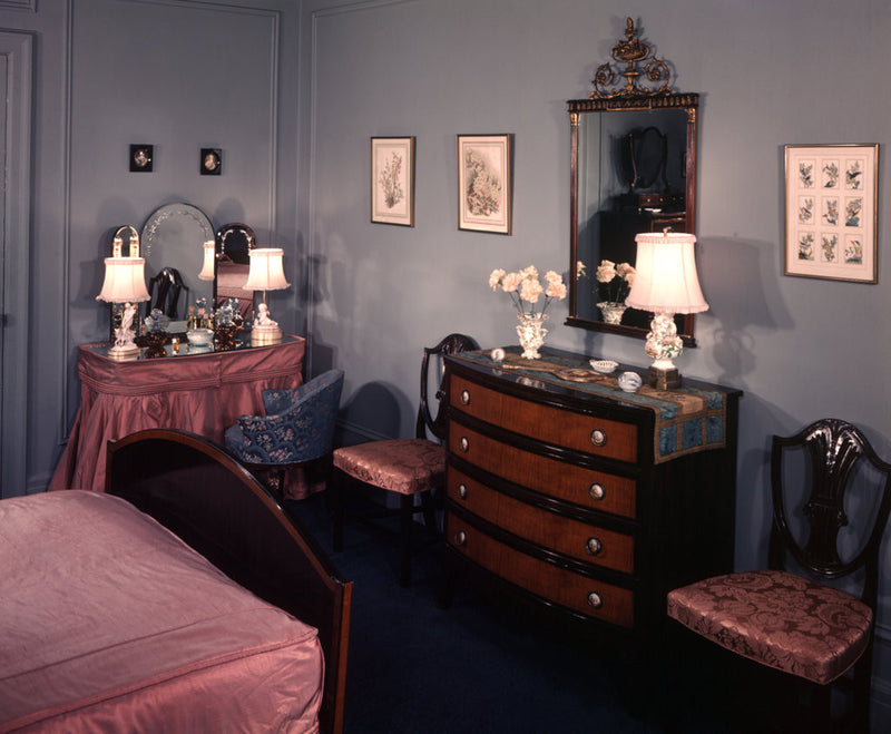 1930s 1940s bedroom with blue walls pink bedspread and skirted vanity table